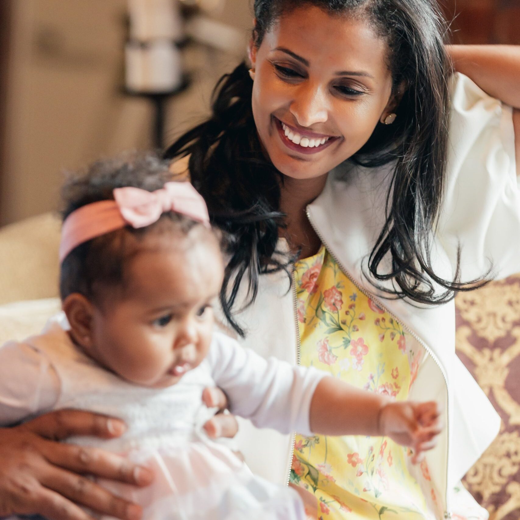 mother-smiles-looking-at-baby-daughter